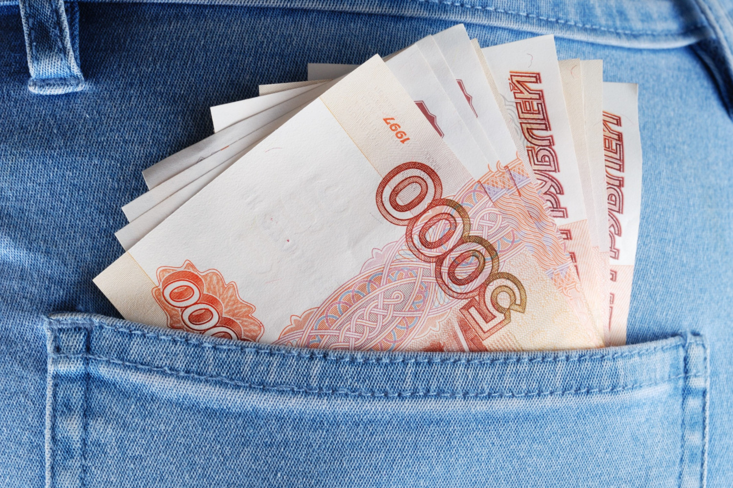 Spending bills. Доллары в кармане фото.
